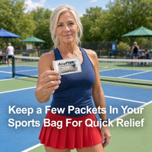 Load image into Gallery viewer, A female Pickleball player holding an AcuPlus Sachet outdoors.